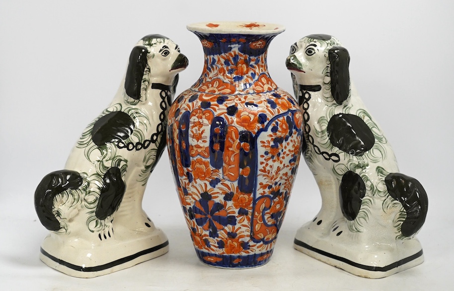 A pair of Victorian comforter spaniels and an Imari vase, vase 31cm high. Condition - fair, vase with a crack to the base